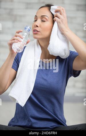 lady essuyant sa sourcils et de l'eau potable après l'exercice Banque D'Images