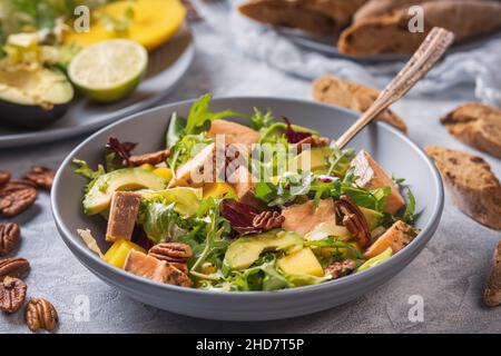 Salade de saumon, de mangue et d'avocat cuite au four avec noix de pécan. Banque D'Images