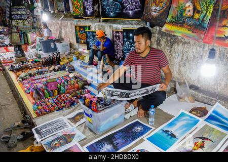 Un détenteur local peint une photo souvenir dans un stand dans le marché nocturne de la rue piétonne dans le centre de Luang Prabang, dans le nord du Laos, dans le sud-est de l'Asie Banque D'Images