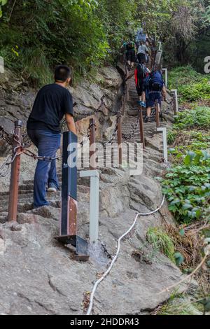 HUA SHAN, CHINE - 4 AOÛT 2018 : les gens grimpent dans les escaliers menant aux sommets de la montagne Hua Shan dans la province de Shaanxi, en Chine Banque D'Images