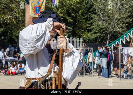 ALCALA DE HENARES, MADRID, ESPAGNE - 12 OCTOBRE 2021 : homme méconnaissable déguisé en arquebusier espagnol qui recharge son dossier pendant la célébration Banque D'Images