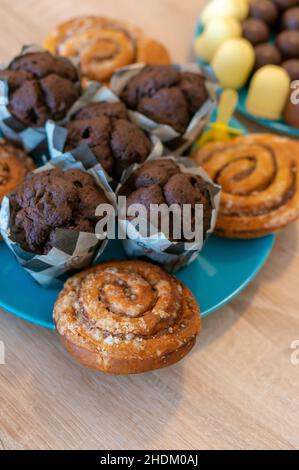 Dose verticale de muffins au chocolat et de petits pains à la cannelle sur une assiette Banque D'Images
