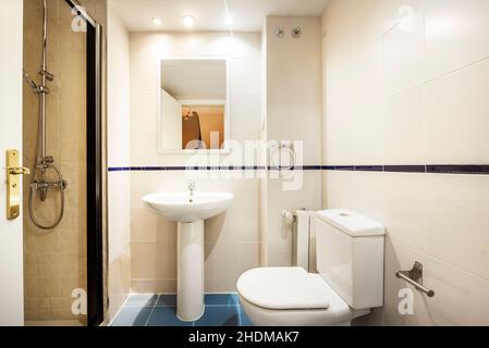 Salle de bains conventionnelle avec douche et miroir dans un appartement de location de vacances Banque D'Images