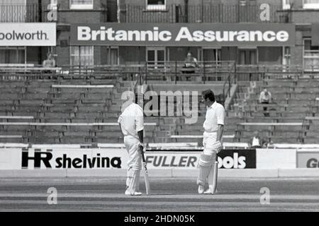 Intikhab Alam (Surrey) bat dans une cause perdante, discute avec Geoff Arnold (Surrey), Surrey vs Essex à l'Oval Cricket Ground, Kennington, Londres, Angleterre, Britannic assurance County Championship, dernier jour du match - 6 juillet 1976. Surrey - le côté intérieur - perdu, et le peu de spectateurs qu'il y avait ont dérivé loin. Banque D'Images