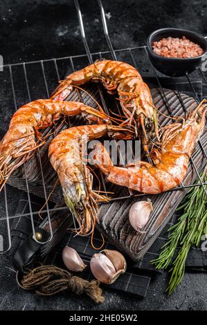 Crevettes tigrées noires grillées sur le gril.Arrière-plan noir.Vue de dessus Banque D'Images