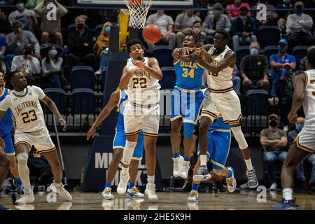 L'avant de la Californie, Andre Kelly (22), Kuany Kuany Kuany (13) et le garde de l'UCLA, David Singleton (34), se disputent une position sur le ballon pendant la seconde Banque D'Images