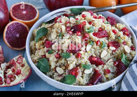 Au-dessus d'un déjeuner sain ou d'un dîner d'une salade de quinoa végétarienne / marocaine avec menthe, grenade et oranges de sang.Mise au point sélective avec flou pour Banque D'Images