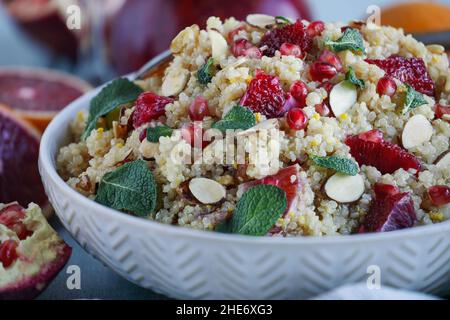 Un déjeuner ou un dîner sain d'une salade de quinoa végétarienne / marocaine à la menthe, à la grenade et aux oranges sanguines.Mise au point sélective avec front flou Banque D'Images