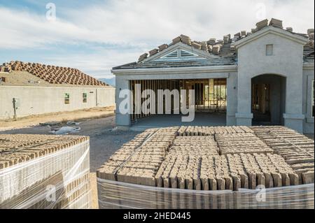 Nouvelle construction de maison avec tuiles de toit en premier plan Banque D'Images