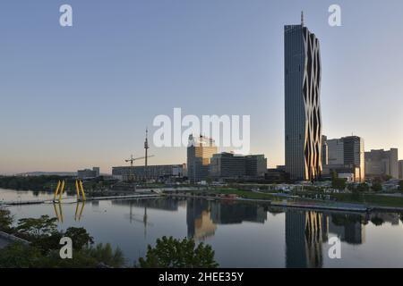 DC Tower 1 - gratte-ciel moderne se reflétant dans le Danube à l'aube, conçu par l'architecte français Dominique Perrault à Vienne en Autriche. Banque D'Images