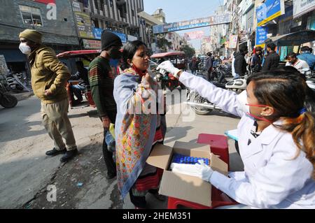 Non exclusif : NEW DELHI, INDE - 11 JANVIER 2022 : les agents de santé effectuent des tests rapides par écouvillonnage auprès des vendeurs locaux pour détecter la maladie de Covid-19 dans le New Delh local Banque D'Images