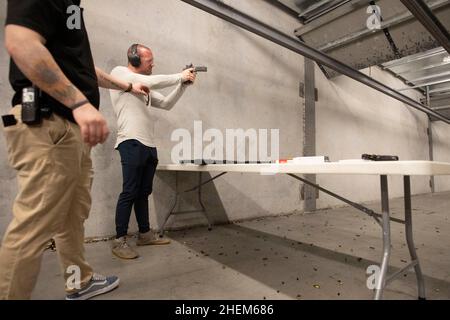 Austin Texas USA, octobre 2021 : Kyle Murphy, membre du Bitcoin Club et organisateur, tourne à The Range, un lieu de tournage en intérieur dans le sud d'Austin, pour un événement social le samedi où les membres ont tiré des centaines de tours à des cibles.©Bob Daemmrich Banque D'Images