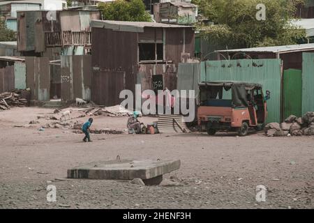 Djibouti, Djibouti - 21 mai 2021 : une petite ville pauvre de chics à Djibouti.Femme assise sous une tente.Animaux à la recherche de nourriture.Un enfant jouant un ga Banque D'Images