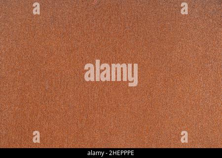 Tôle rouillée avec corrosion orange uniforme dans un éclairage uniforme.Arrière-plan. Banque D'Images