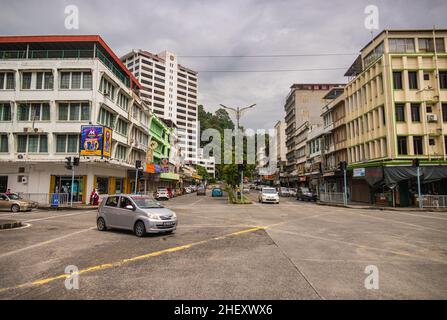 Sandakan, Malaisie - 06 janvier 2022 : paysage urbain de la ville de Bornéo.Maisons délabrées et vieilles voitures malaisiennes dans la rue.Deuxième plus grande ville de Sabah Banque D'Images