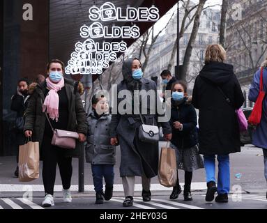 Paris, France.12th janvier 2022.Les gens passent devant les panneaux de vente d'hiver devant les Galeries Lafayette à Paris, France, le 12 janvier 2022.Les ventes d'hiver en France ont débuté mercredi et se feront jusqu'au 8 février.Credit: Gao Jing/Xinhua/Alamy Live News Banque D'Images