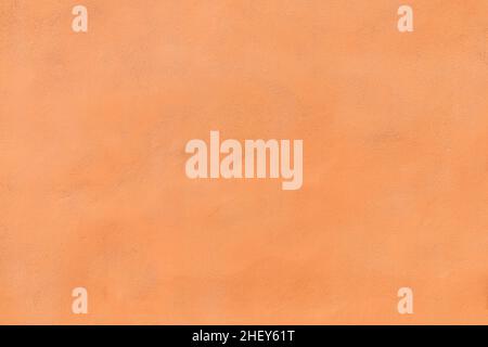 fond de mur en plâtre orange harmonique en détail Banque D'Images