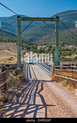 Camion-camping au pont suspendu au-dessus de Green River, Browns Park NWR, Colorado, États-Unis Banque D'Images