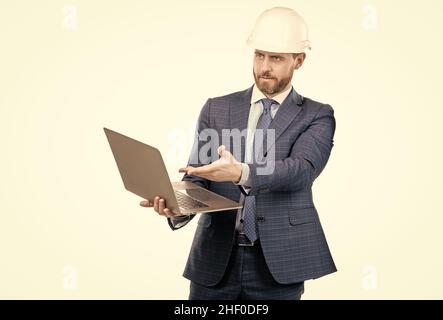 Ingénieur professionnel dans hardhat point à l'écran d'ordinateur portable pour l'ingénierie, les logiciels d'ordinateur Banque D'Images