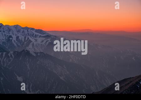 Atmosphère magique d'un coucher de soleil dans les montagnes ; ciel de coucher de soleil sur des crêtes de montagne enneigées Banque D'Images