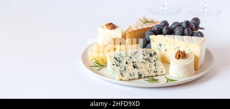 Assiette de fromage servie avec des raisins et des noix, espace de copie Banque D'Images