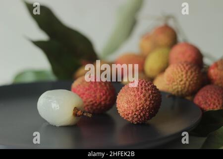 Lychee sur fond blanc.Le litchi chinensis est aussi épelé litchi ou lichi, un arbre à feuilles persistantes de la famille des Sapindaceae, gr Banque D'Images