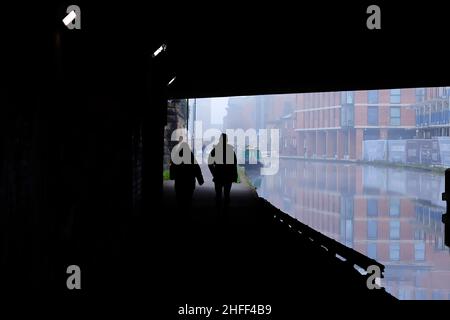 Silhouettes sous un pont à côté du canal Leeds-Liverpool dans le centre-ville de Leeds Banque D'Images