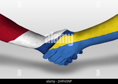 Poignée de main entre l'ukraine et les pays-bas drapeaux peints sur les mains, illustration avec chemin de coupure. Banque D'Images