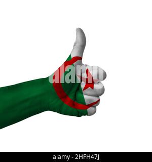 Main making pouces vers le haut signe, l'algérie peint avec le drapeau comme symbole de pouces vers le haut, comme, d'accord, positif - isolé sur fond blanc Banque D'Images