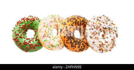 Quatre beignets colorés isolés sur un fond blanc avec un chemin d'écrêtage.Pose à plat Banque D'Images