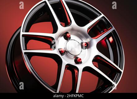 magnifiques roues en alliage rouge gros plan, écrous de roue de style sportif en rouge sur fond noir dégradé pièces auto. Banque D'Images