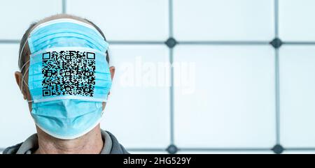 Homme avec visage couvert de masques médicaux et code qr.Le concept de contrôle total du gouvernement sur les gens et de résistance anti-vaxer Banque D'Images