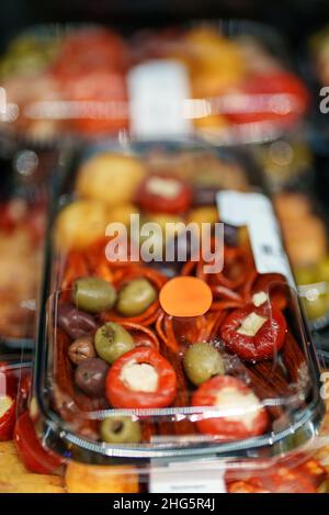 En-cas au supermarché.Olives, pepperoni et tomates farcies. Banque D'Images
