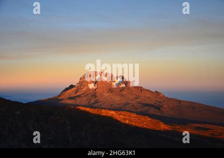 Le mont Mawenzi brille dans les derniers rayons du soleil. Coucher de soleil à kilimanjaro. Trekking sur la plus haute montagne d'Afrique Banque D'Images
