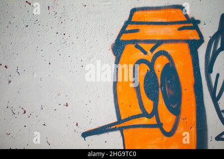 Fragments d'une personne caricaturée.Le mur est peint avec de la peinture en aérosol.Texture murale graffiti en béton. Banque D'Images