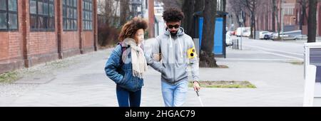 Jeune homme africain aveugle traversant la rue avec Cane Banque D'Images