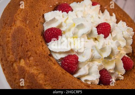 Pâtisserie, gâteau traditionnel italien au rhum avec crème fouettée et framboises Banque D'Images