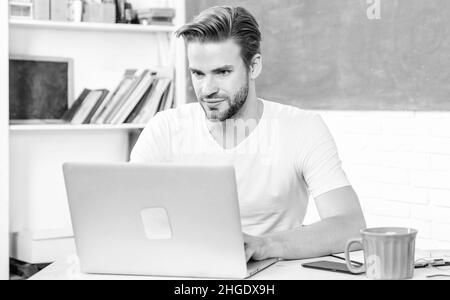bibliothèque en ligne. école de vie. professeur d'école utiliser un ordinateur portable et un smartphone. étudiant homme en classe avec une tasse de thé. éducation moderne. retour à l'école Banque D'Images