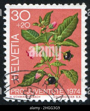 SUISSE - VERS 1974: Timbre imprimé par la Suisse, montre Belladonna, plantes, vers 1974 Banque D'Images