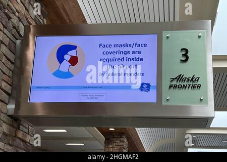 Un panneau d’avis de mandat de masque facial fédéral à un carrousel de récupération des bagages de l’aéroport international de Reno au milieu de la vague de la variante omicron du coronavirus COVID-19, vendredi 14 janvier 2022, à Reno, Nevada. Banque D'Images