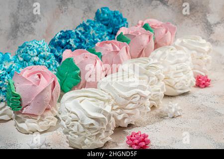 Guimauves faites à la main sur fond clair sous forme de roses, d'hortensias et de tulipes.Il y a des fleurs à proximité.Journée des femmes, Saint-Valentin. Copie Banque D'Images