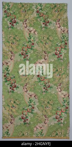 Longueur 18th Century French cette robe de soie française est une combinaison complexe de textures et de couleurs: Des banderoles argentées et dorées et des guirlandes florales serpentent sur un fond qui présente un motif vert brillant d'une petite vigne fleurie.Le textile emploie six fils métalliques différents, plus douze couleurs de soie.La superposition de banderoles côte à côte avec des pulvérisations florales et des guirlandes est typique de la 1760s, et la formule a été utilisée à plusieurs reprises avec des variations représentant le ruban, la dentelle, ou la fourrure.Le fil de chenille de Velvetlike a parfois été utilisé au lieu de fil de métal.lorsqu'il est composé en une femme Banque D'Images
