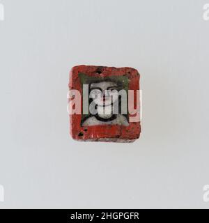 Inlay / perle blanc avec face 100 BC–100 AD période Ptoléméenne–période romaine Une technique de mosaïque de verre a permis de créer des multiples d'une image: Une composition figurale ou design a été faite en regroupant des cannes en verre coloré, qui ont ensuite été tirées dans une longue barre.La barre a ensuite été sectionnée à angle droit, probablement en frappant la barre avec les outils appropriés, pour produire de petits carreaux incrusts.Le carreau serait alors lissé et poli sur la face destinée à apparaître vers l'extérieur.Incrustation / cordon avec face.100 BC–100 AD.Verre.Période Ptolemaic–période romaine.De l'Égypte Banque D'Images