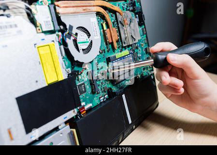 Le technicien de maintenance installe de nouvelles puces sur l'ordinateur portable.Réparation et mise à niveau du concept d'ordinateur portable.Gros plan. Banque D'Images
