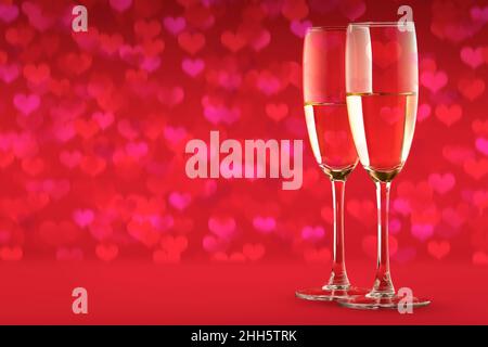 Deux verres avec un verre de champagne sur fond rouge de coeurs. Un symbole de célébration, d'amour ou un dîner festif en l'honneur de la Saint-Valentin Banque D'Images