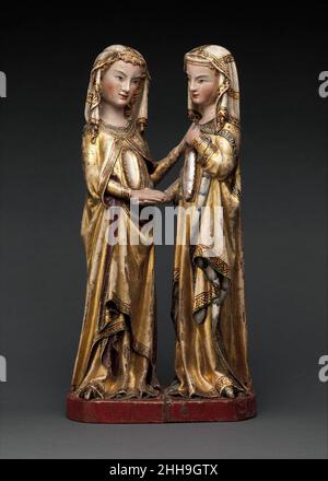 La Visitation ca.1310–20 attribuée à Maître Heinrich de Constance peu après que la Vierge Marie ait appris sa conception miraculeuse de Jésus, elle a visité sa relative Elizabeth, qui attendait aussi un enfant, Jean-Baptiste.Cette représentation de leur réunion joyeuse vient du couvent dominicain de Katharinenthal, dans la région du lac de Constance de la Suisse d'aujourd'hui.Sculptés de noyer, avec la peinture d'origine et la dorure presque complètement préservée, les figures de Marie et d'Elizabeth sont chacune incrustées de cavités couvertes de cristal à travers lesquelles les images de leurs enfants peuvent à l'origine ha Banque D'Images
