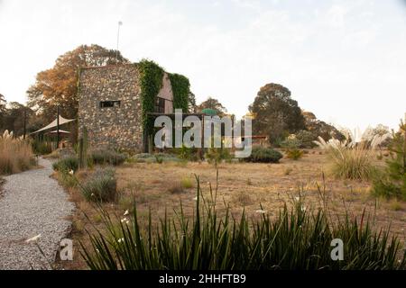 Chemin en pierre menant à l'élégante architecture d'une maison en pierre construite dans la campagne en plein soleil Banque D'Images