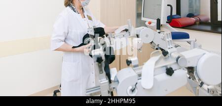 Patient sur des machines à plage de mouvement passive continue.Dispositif permettant un mouvement anatomique correct de la cheville et des articulations.Pied Banque D'Images