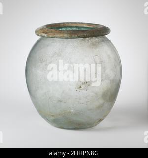 Rte cineraire en verre (olla) mi-1st–mi-2nd siècle A.D. Roman bleu translucide vert.large, éverté, rebord tubulaire, fait en repliant, vers le bas, rond, et dans, avec la surface supérieure biseautée; corps ovoïde; fond concave.intact; quelques bulles; léger morcellement,Faible iridescent, et les intempéries brunâtres, avec une grande pièce de limie encastarnement à l'extérieur, et brillant irisée à l'intérieur de la jante tubulaire.verre soufflé.Urne en verre (olla).Romain. Mi-1st–mi-2nd siècle A.D..Verre ; soufflé.Impériale.Verre Banque D'Images