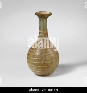 Flacon de parfum en verre 1st Century A.D. Roman bleu translucide vert, avec sentier de la même couleur. Rebord replié, rond et intérieur; col court et évasé;Col cylindrique, en expansion vers le bas; corps globulaire; fond légèrement aplati.un seul chemin appliqué sur le cou et dessiné vers le bas dans une spirale, se terminant sur le fond.intact; bulles de piqûre; piqûres et intempéries irisées.Flacon de parfum en verre 239798 Banque D'Images